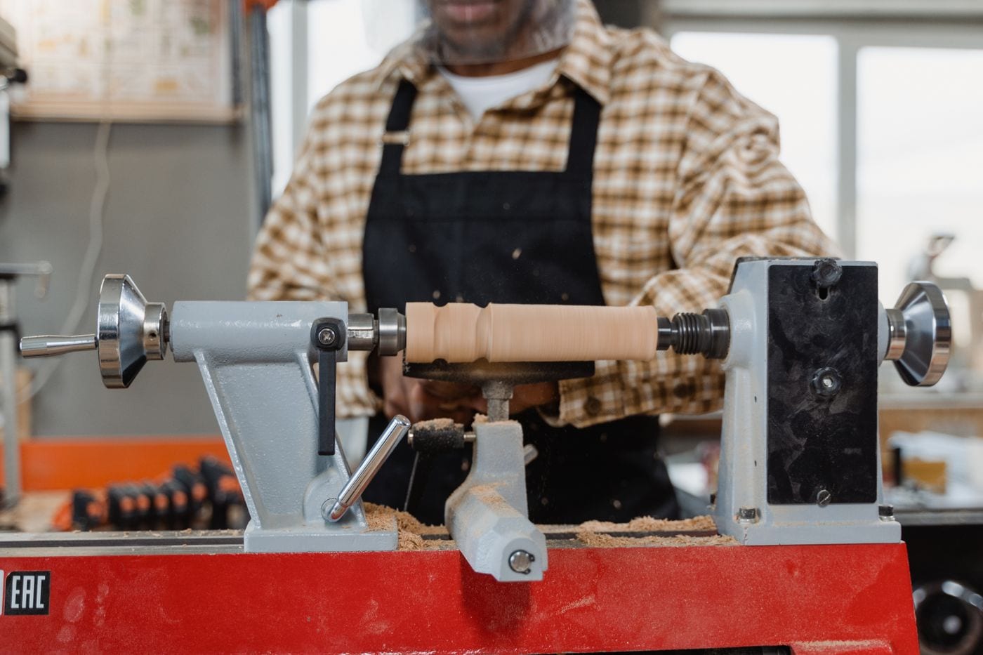 A turner working between centers at a wood lathe