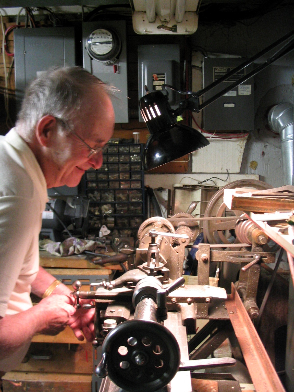 Lynn working at his vintage wood lathe in a home workshop setting