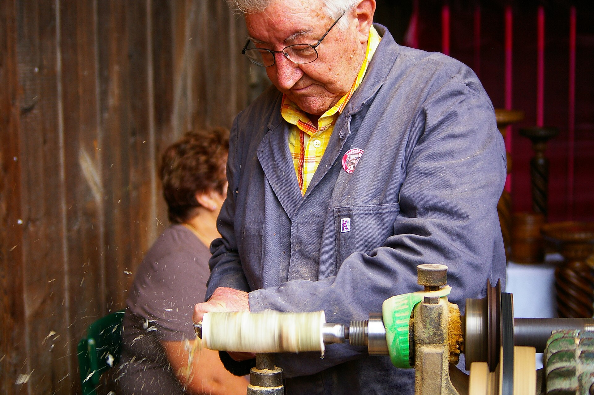 A woodturner shaping a spindle on a lathe