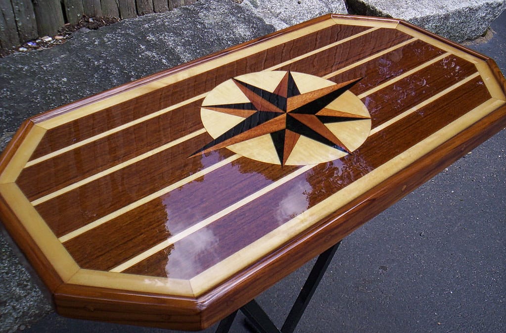 Close-up of a wooden surface with clear epoxy resin filling the grain lines and natural voids of the wood