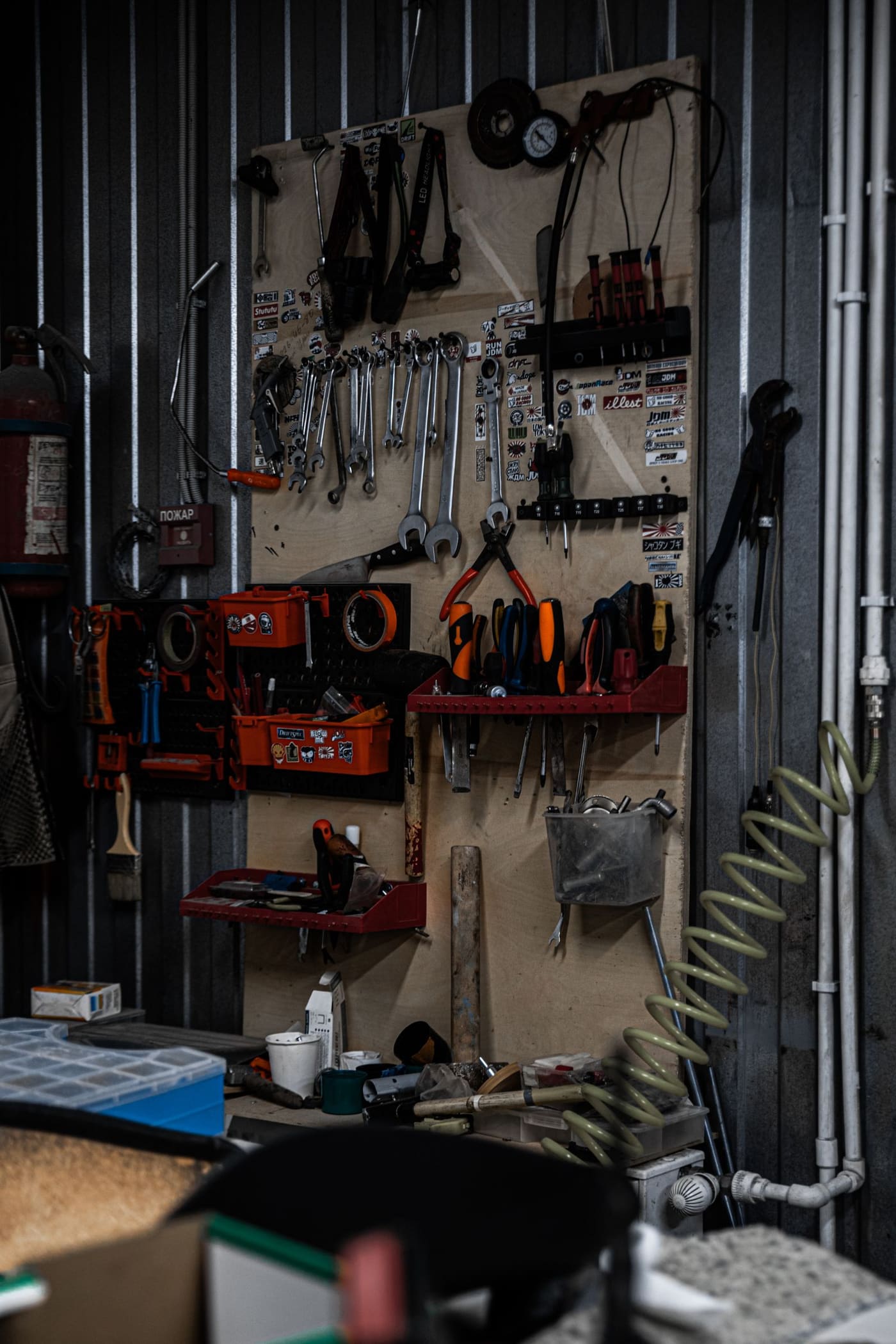A home workshop with hand tools organized on a wall, the kind of dedicated corner suited to running a vacuum pump