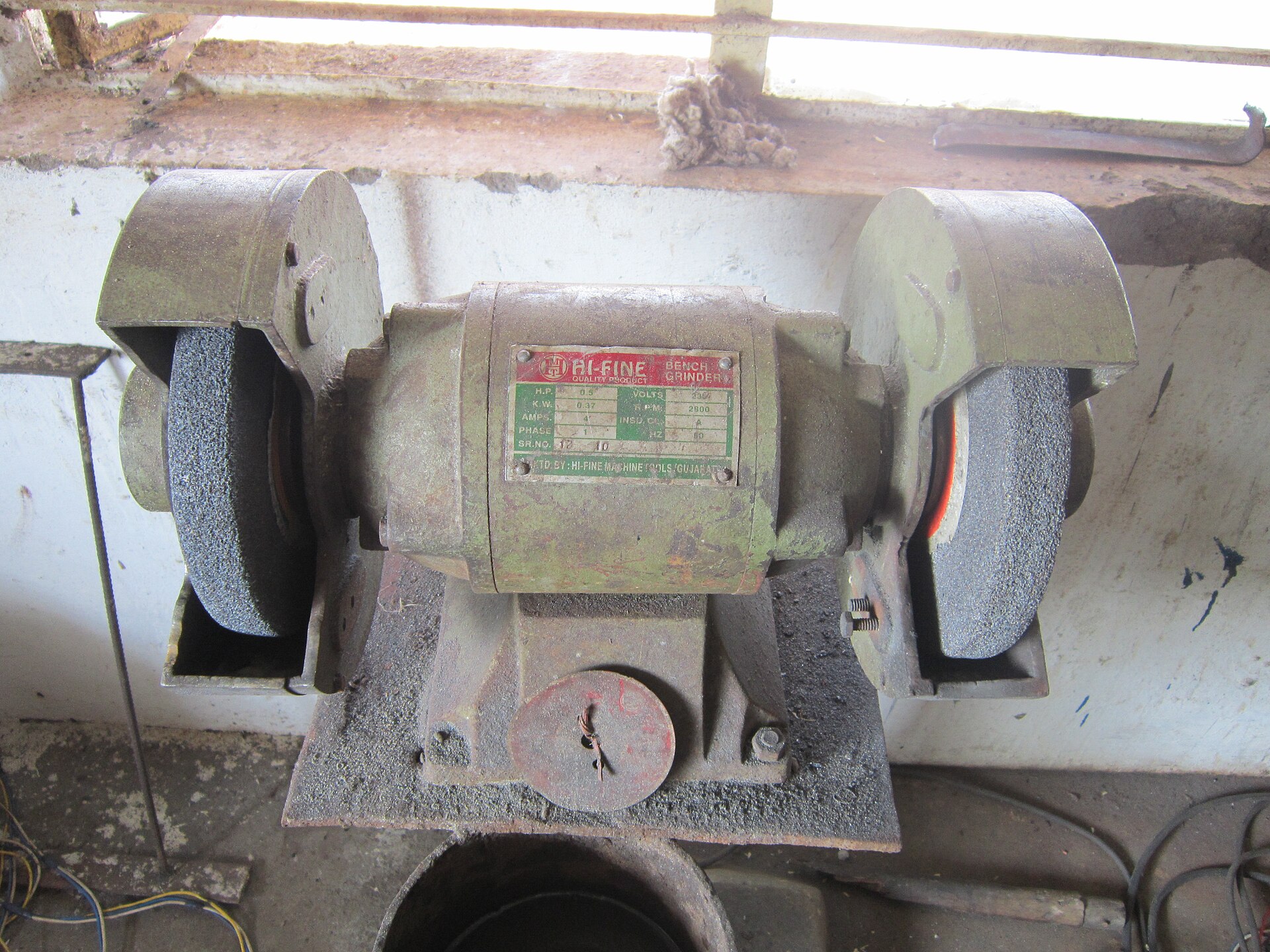 A bench grinder set up in a workshop